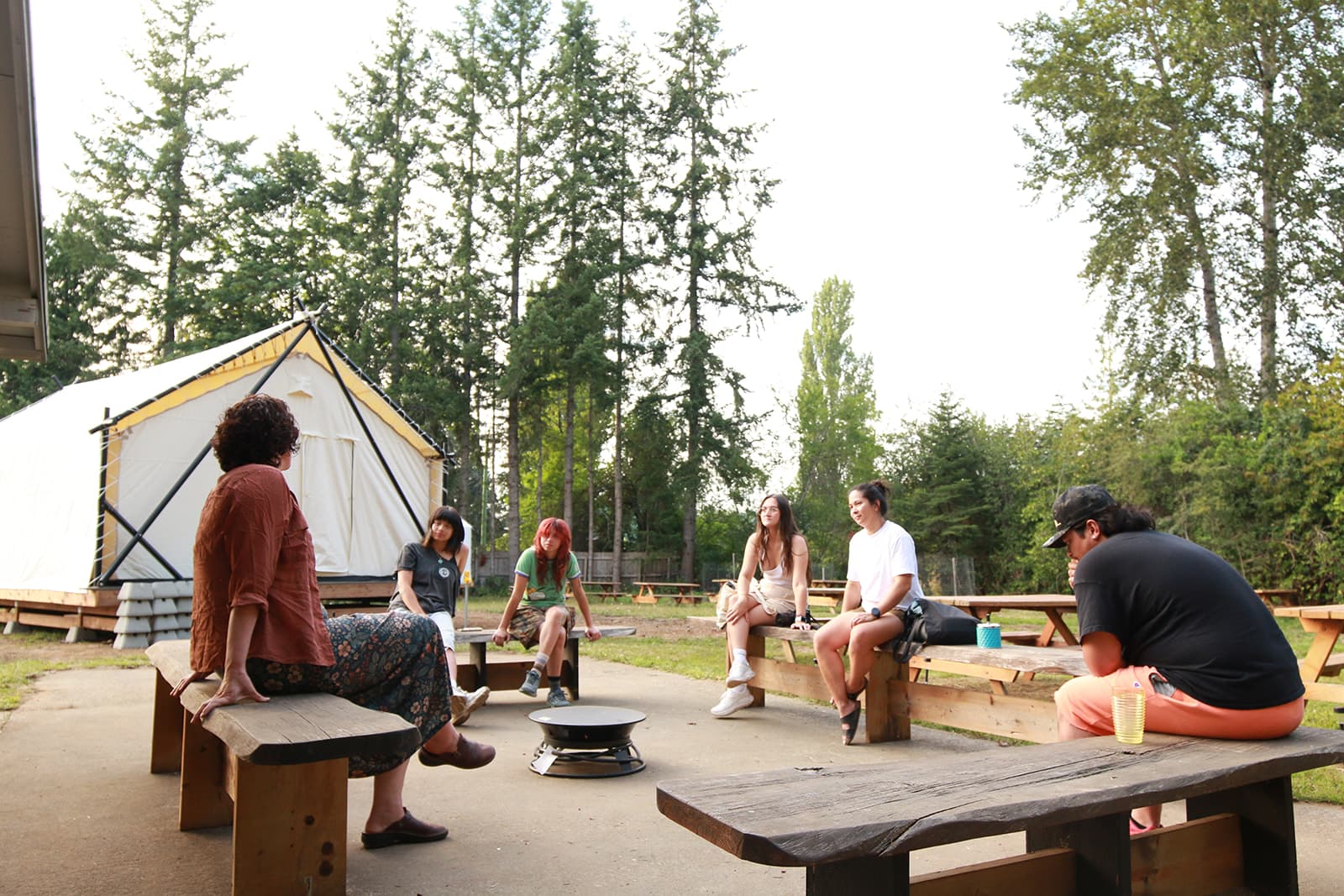 Campers gathered outdoors in conversation