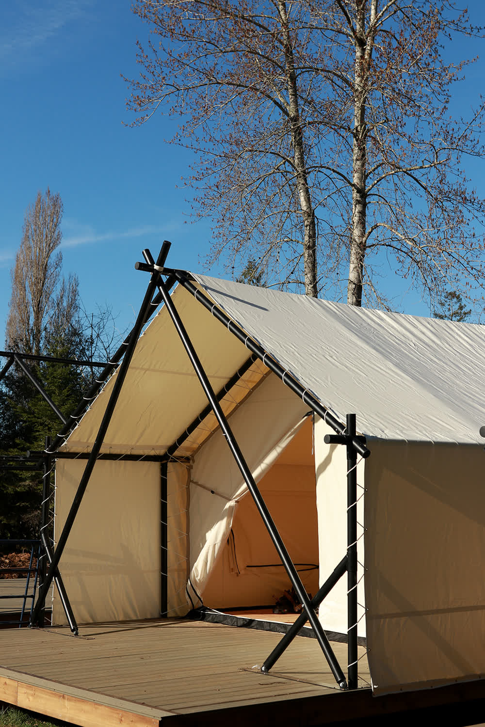 A canvas tent among the trees at Camp Denman