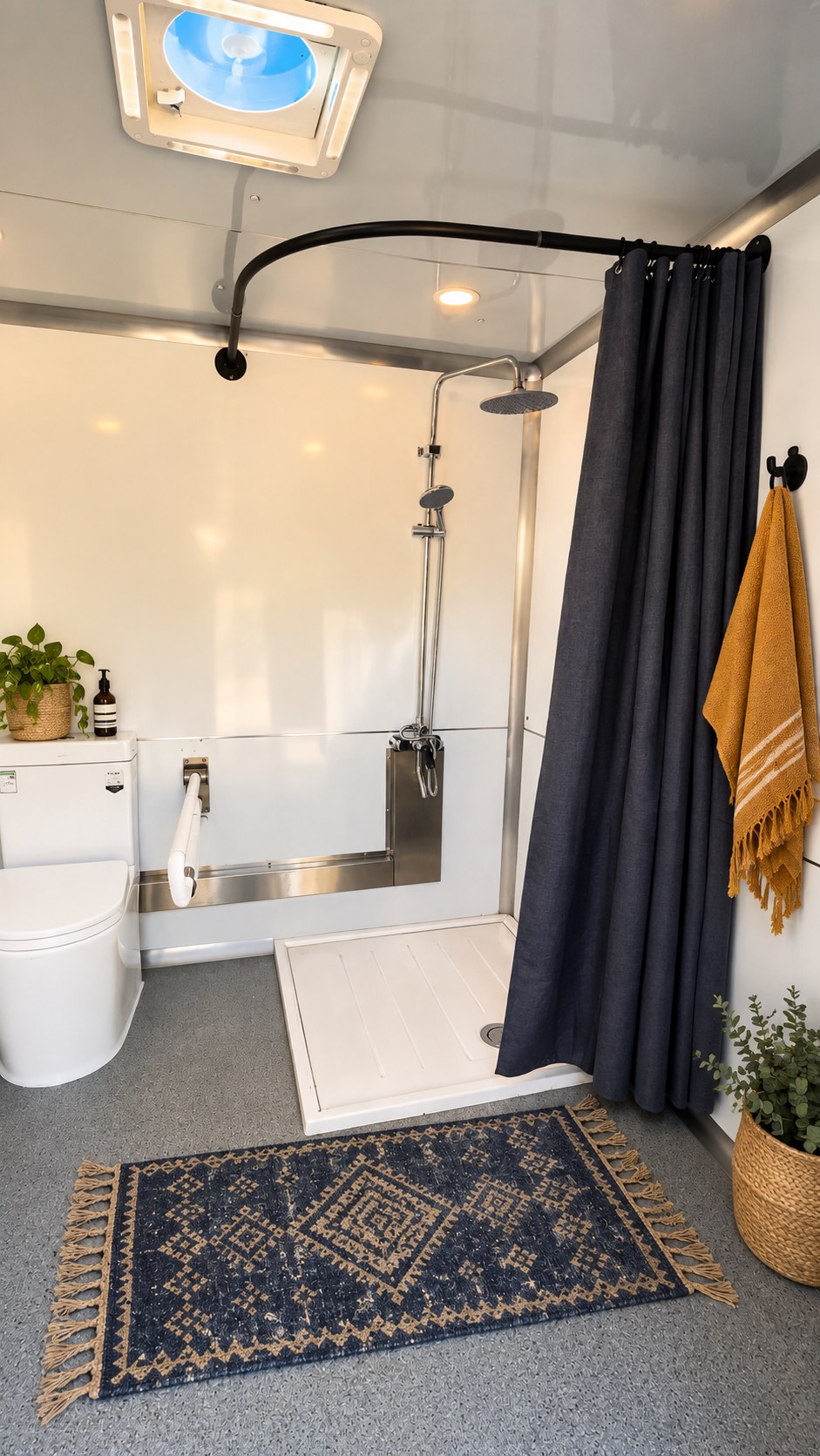 The accessible stall's roll-in shower with grab bars