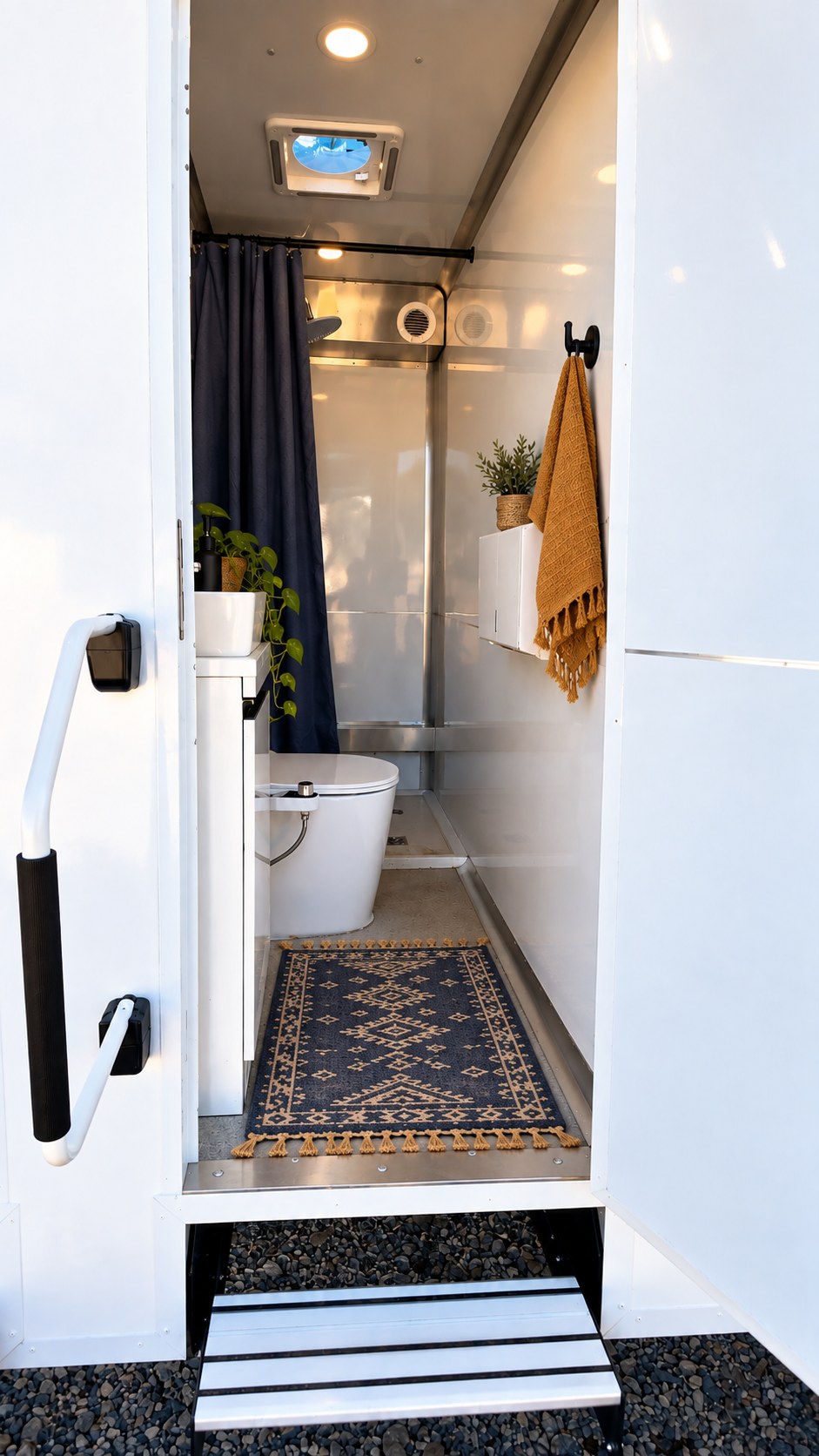 Inside a standard bathroom stall, with shower, toilet, and sink