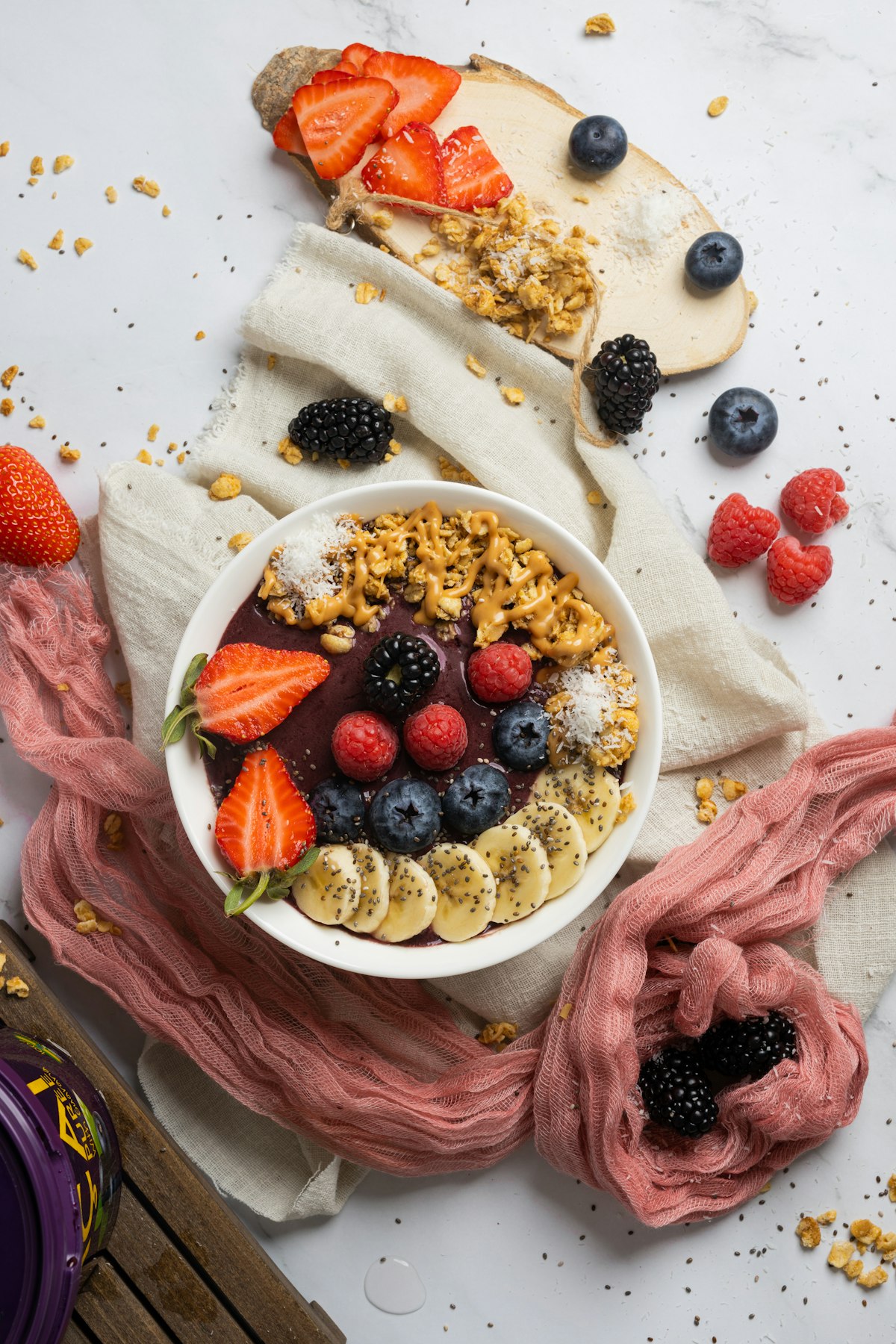 An overhead smoothie bowl breakfast spread