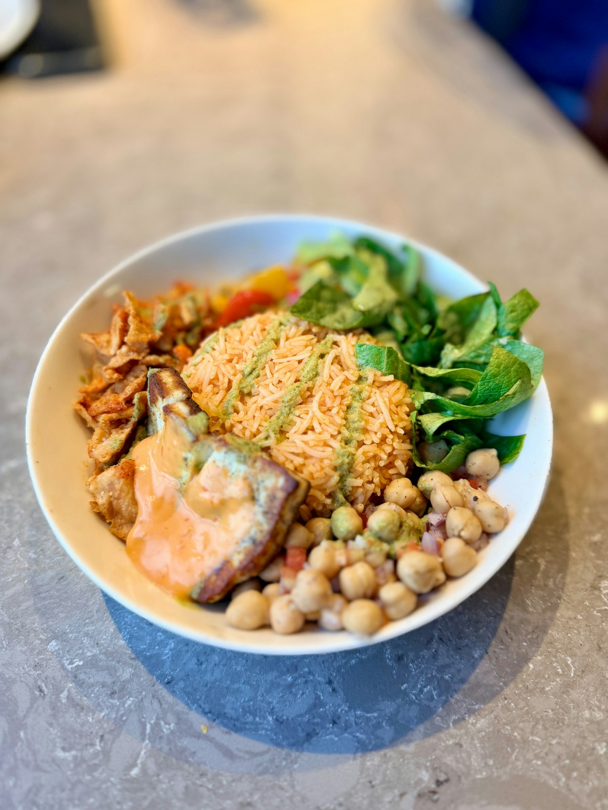 A rice bowl with salad and chickpeas