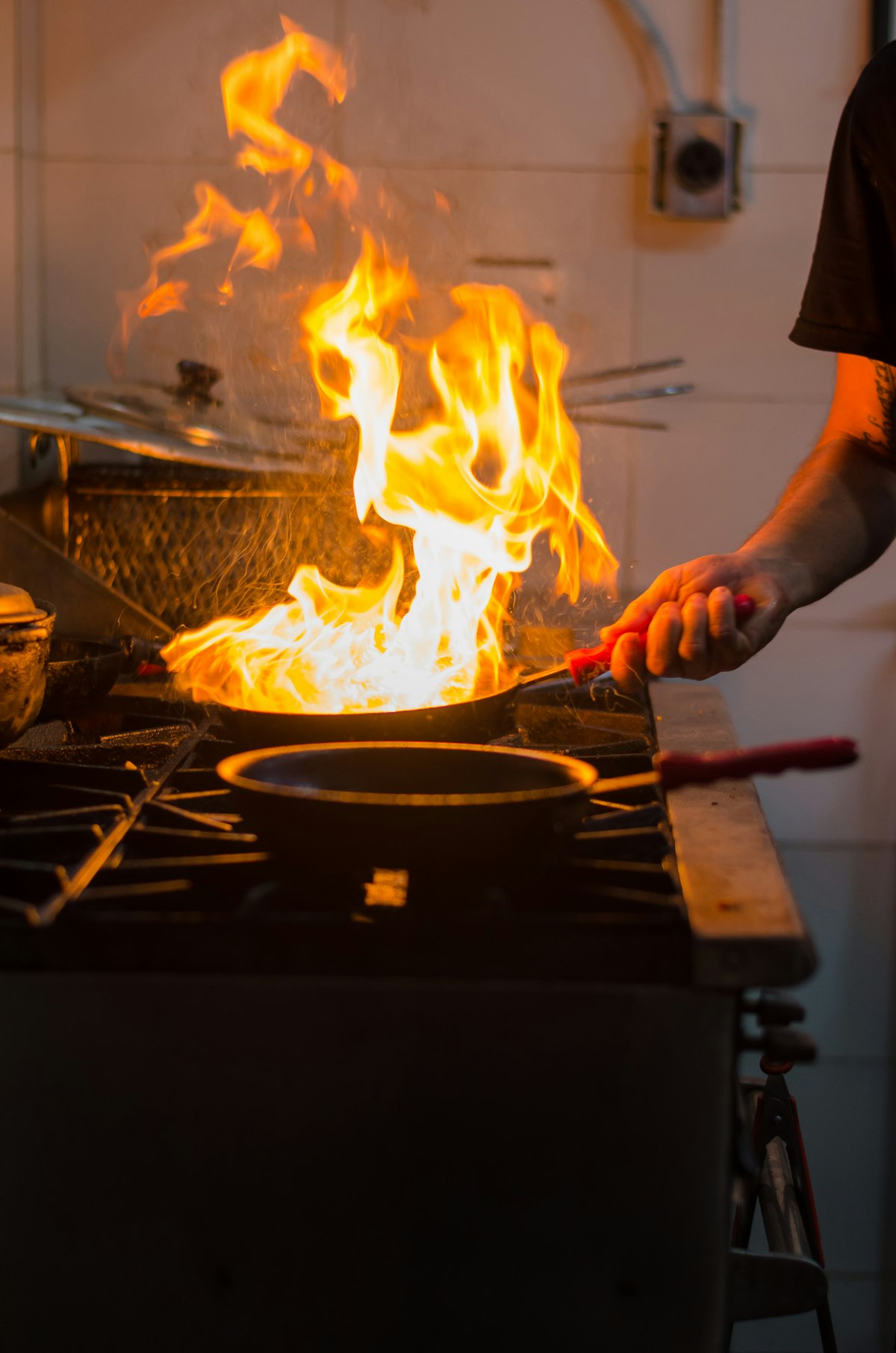Close-up of a pan flambéing over an open flame
